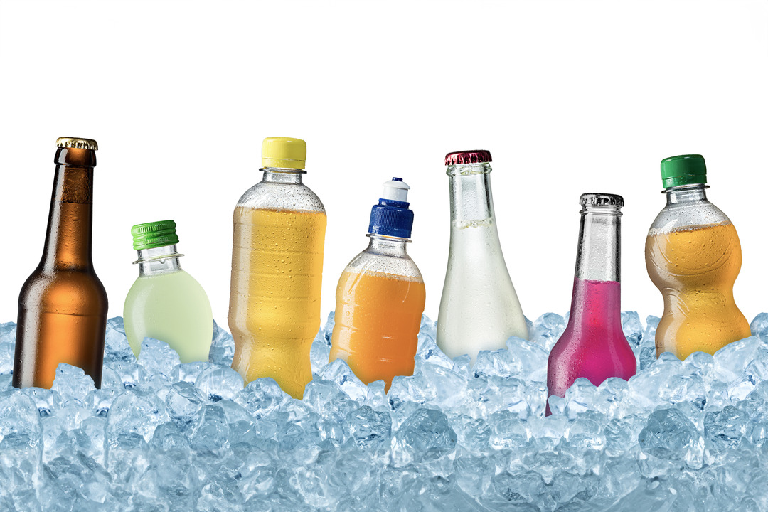 Range of colorful soft drinks on crushed ice