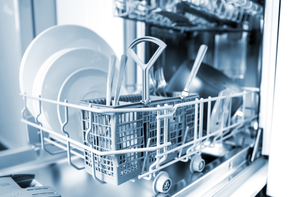 Open dishwasher with clean glass and dishes, selective focus