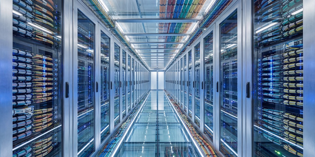 Modern Data Center Server Room with Rows of Racks and Cables.