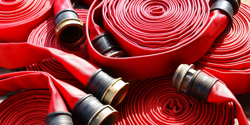 Red fire hoses rolled up 